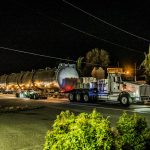 Omega Morgan carefully maneuvers their load under low-hanging wires.