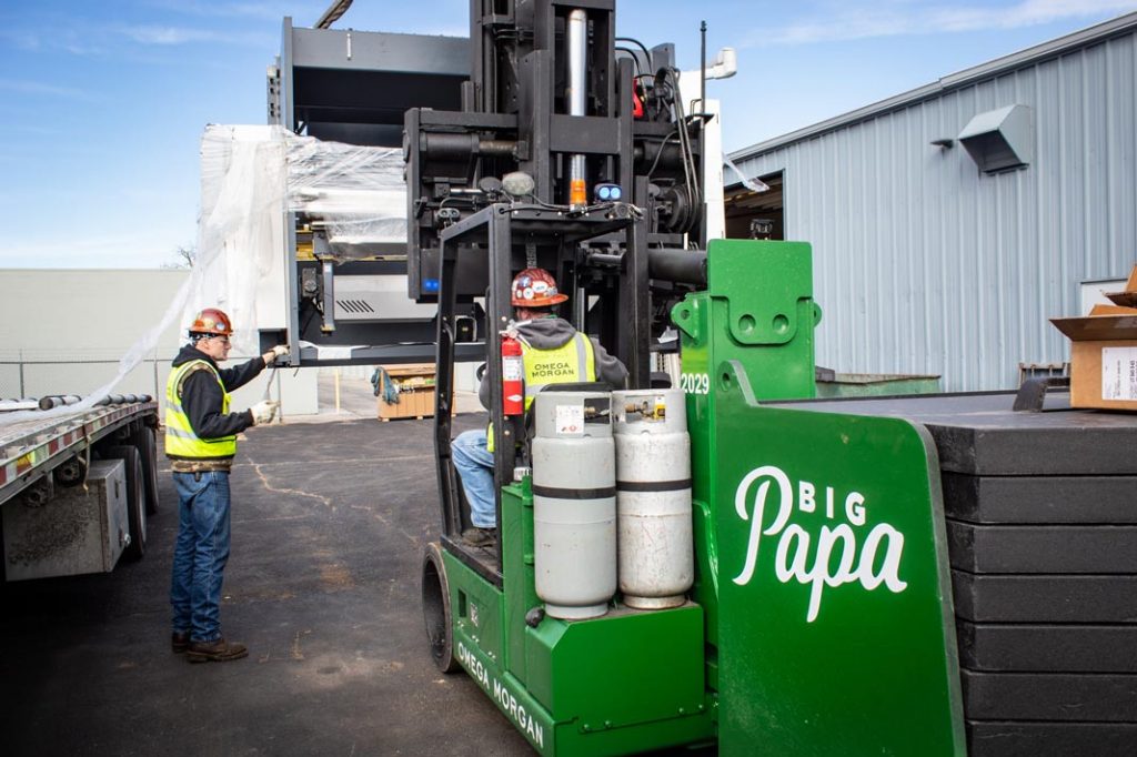 Omega Morgan Machinery Moving team using “Big Papa”, a Hoist FR 40/60 forklift, to move metal fabrication equipment