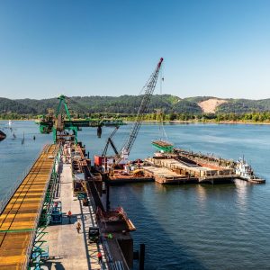 The Omega Morgan millwright team carefully moves a 130,000 lb bridge span into place.