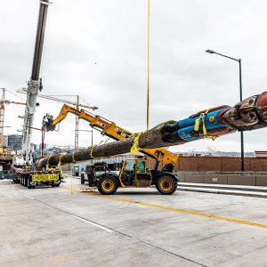 The Omega Morgan crane crew prepares to remove and lower the totem pole.
