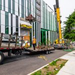 Omega Morgan crane crew preparing supplies for their ride from the ground to the building's rooftop.