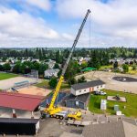 An overhead view of one half of a modular classroom being moved by Omega Morgan’s 350-ton crane.
