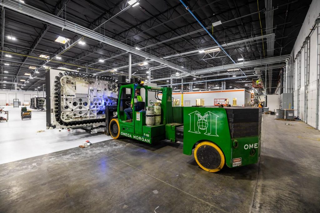A Spindle Machine is being driven to its new location by Omega Morgan’s heavy equipment movers.