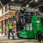 A machinery moving team member inspects the new conveyor location.