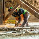 An Omega Morgan team member welding footings in place for a safe relocation.