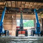 Three Telehandler All-Terrain Forklifts are lined up and ready to work together to move a flight conveyor into its new location.