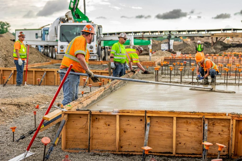 The millwright service crew spreading 500 cubic yards of finished concrete in their forms.