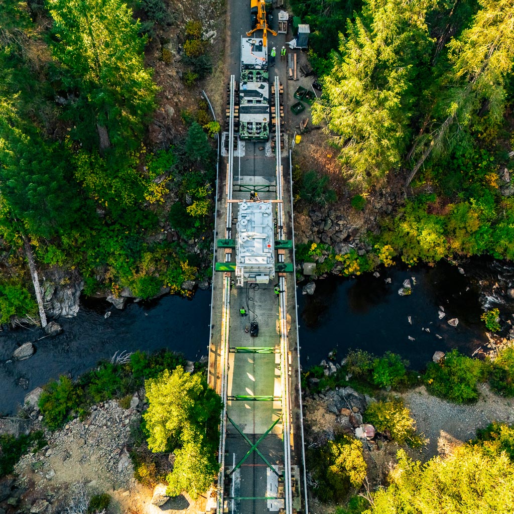 Omega Morgan’s specialized transportation crew transports a transformer over a bridge.