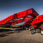 A crew member stands next to a 500-ton suspension trailer.