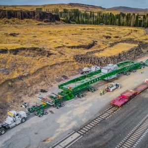 image from the sky of the huge transformer, trailer, trucks and crew for this specialized moving project