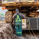 A crew member uses special heavy haul trucking equipment to load a mining shovel onto an Omega Morgan trailer.