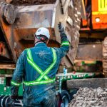 An Omega Morgan crew member guides the specialized transportation trailer as it slides under a 600,000-pound mining shovel.