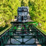 Omega Morgan crews slide a transformer over a bridge.