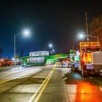 The Omega Morgan crew makes a sharp turn while carrying a transformer to its new location.