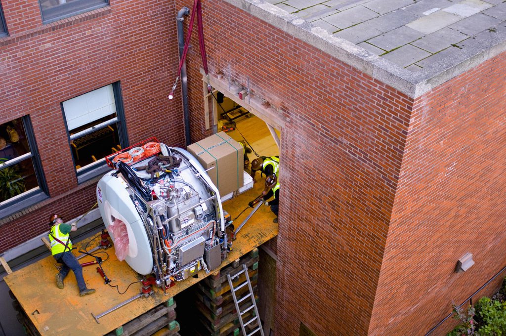 Moving MRI unit into hospital’s 2nd floor the old fashion way: crib blocks and steel plate