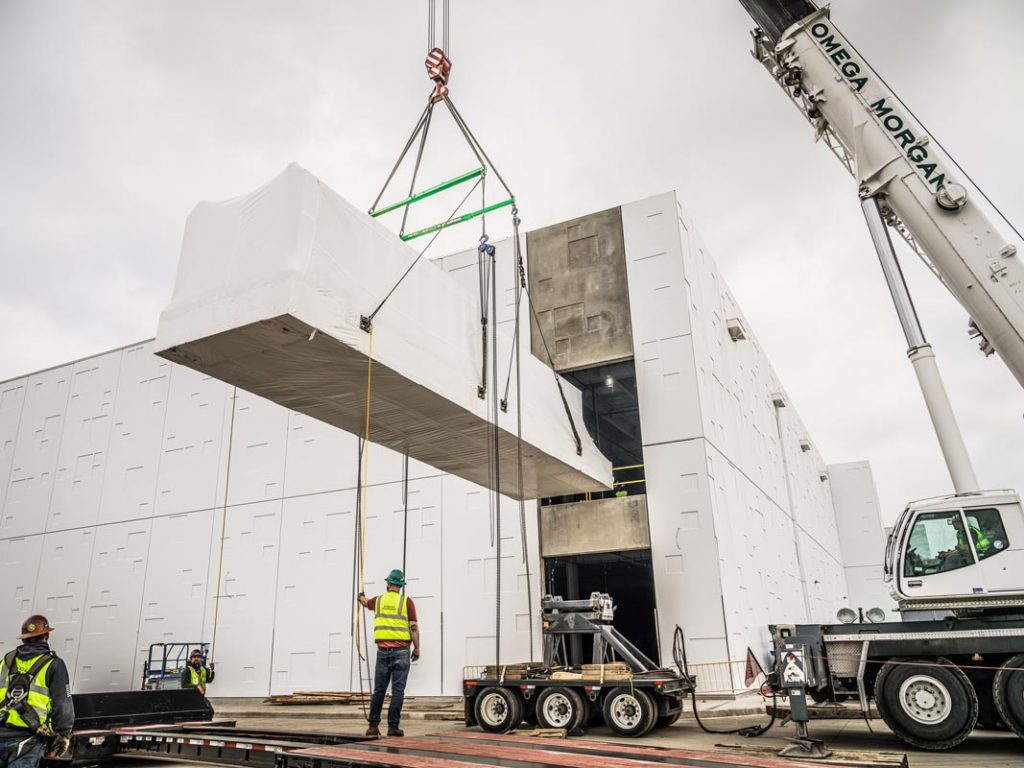 Omega Morgan Machinery Moving and crane crews lifting power skids into the JE Dunn Data Center in Oregon