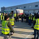 Omega Morgan’s Dallas equipment moving team meets for a pre-task safety meeting.