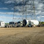 Wind energy component lifted above its saddles by Omega Morgan’s specialized transportation team and double Schnabel trailer.